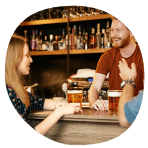 field rep chatting with pub manager over pints of beer