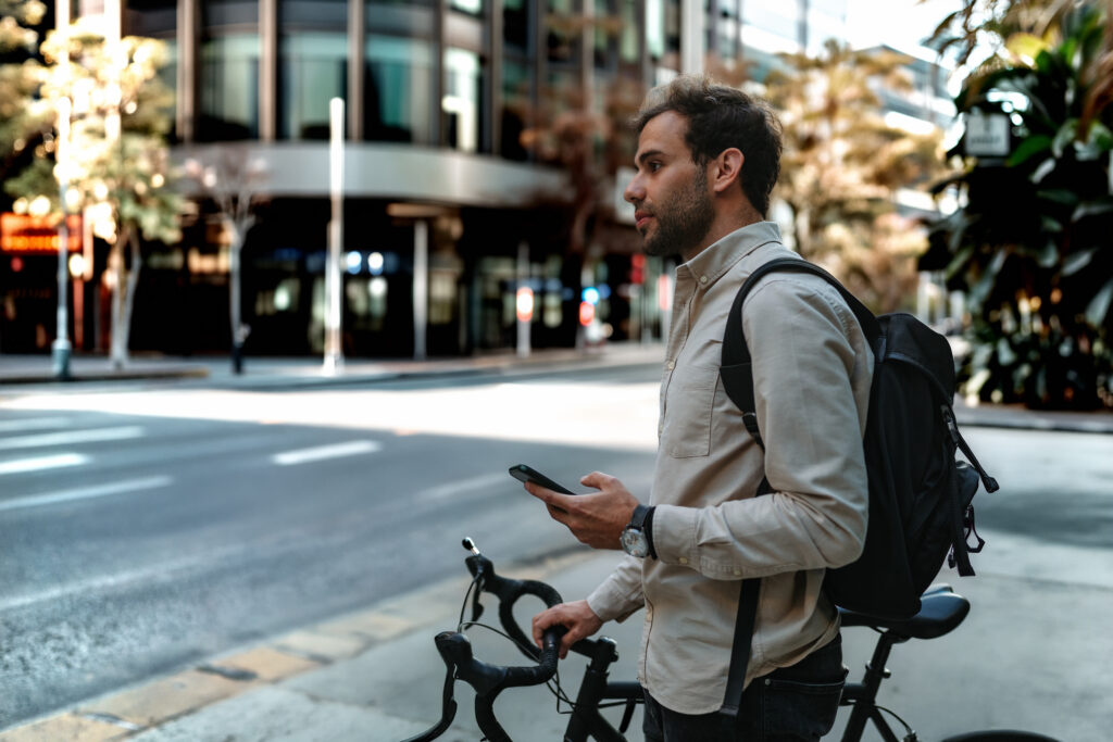 Man on bike checking route on phone