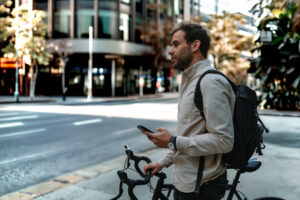 Man on bike checking route on phone