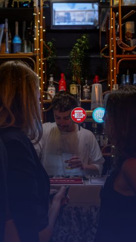 Women Stood at Bar Serving Beer
